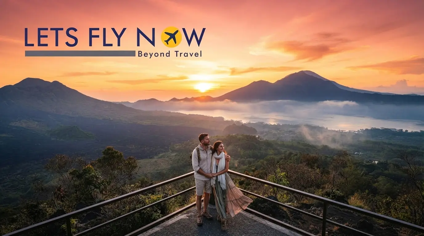 Couple watching the sunrise over Bali's Mount Batur volcanic landscape
